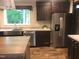 Modern kitchen features stainless steel appliances, a large window, and sleek granite countertops at 550 Saplin Branch Rd, Timberlake, NC 27583
