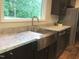 Modern kitchen with a stainless steel farmhouse sink, granite countertops, and stainless steel appliances at 550 Saplin Branch Rd, Timberlake, NC 27583