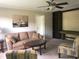 Comfortable living room with a cozy sofa, decorative artwork, ceiling fan and custom built-in wall unit at 550 Saplin Branch Rd, Timberlake, NC 27583