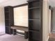 Living room features a custom built-in wall unit, providing ample storage and display space with shelves and a workspace at 550 Saplin Branch Rd, Timberlake, NC 27583