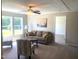 Bright living room with large windows, a comfortable sofa, and stylish decor, offering a welcoming atmosphere at 550 Saplin Branch Rd, Timberlake, NC 27583