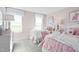 Charming bedroom with pink walls, plush bedding, and whimsical decor at 569 Freedom Trail Dr, Willow Springs, NC 27592