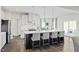 Kitchen island with pendant lights, seating, modern cabinets, and stainless appliances create a stylish focal point at 569 Freedom Trail Dr, Willow Springs, NC 27592