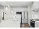 Modern kitchen with white cabinets, stainless steel appliances and a herringbone backsplash offers a sleek design at 569 Freedom Trail Dr, Willow Springs, NC 27592