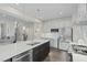Modern kitchen with white cabinets, stainless steel appliances and a herringbone backsplash offers a sleek design at 569 Freedom Trail Dr, Willow Springs, NC 27592