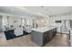 Open-concept kitchen and living room with hardwood floors, an island and comfortable seating at 569 Freedom Trail Dr, Willow Springs, NC 27592