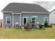 View of the backyard featuring a patio area, grill, and well-maintained lawn at 633 Longstanton Ave, Zebulon, NC 27597
