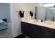 Bathroom featuring a dark vanity and shower, accessible from the connected bedroom at 633 Longstanton Ave, Zebulon, NC 27597