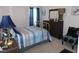 Serene bedroom featuring a striped bedspread, wood furniture, and soft blue accents at 633 Longstanton Ave, Zebulon, NC 27597