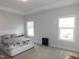 Bright bedroom features neutral walls, plush carpet, and a large bed beneath a tray ceiling at 633 Longstanton Ave, Zebulon, NC 27597