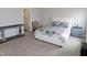 Well-lit bedroom showcases patterned bedding and an adjacent doorway leading to an en-suite bath at 633 Longstanton Ave, Zebulon, NC 27597