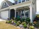 Charming home exterior with a welcoming porch and colorful landscaping at 633 Longstanton Ave, Zebulon, NC 27597