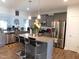 Modern kitchen featuring stainless steel appliances, a center island, and granite countertops at 633 Longstanton Ave, Zebulon, NC 27597