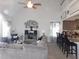 Open-concept living room featuring a ceiling fan and seamless view to the kitchen breakfast bar at 633 Longstanton Ave, Zebulon, NC 27597