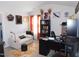 Bright office features a white couch, black bookshelves, and an efficient desk setup at 633 Longstanton Ave, Zebulon, NC 27597