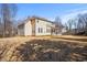 Exterior rear view of house showing the backyard and fence with beautiful trees at 704 Valleywater St, Fuquay Varina, NC 27526
