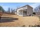 Large backyard view featuring a fence, a screened in porch, and the exterior of the home at 704 Valleywater St, Fuquay Varina, NC 27526