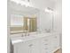 Bathroom featuring a double vanity, large mirror, and a separate shower and soaking tub at 704 Valleywater St, Fuquay Varina, NC 27526
