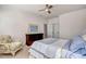 Calm bedroom with a ceiling fan, neutral walls, big windows, carpet, and a comfy floral armchair at 704 Valleywater St, Fuquay Varina, NC 27526