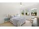 Comfortable bedroom with soft carpet, a ceiling fan, and natural light from multiple windows at 704 Valleywater St, Fuquay Varina, NC 27526