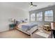 Bright bedroom with a ceiling fan, neutral walls, large windows, and cozy carpet, creating a relaxing atmosphere at 704 Valleywater St, Fuquay Varina, NC 27526