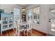 Bright breakfast nook features a table and chairs by the window, alongside blue decor and wood floors at 704 Valleywater St, Fuquay Varina, NC 27526
