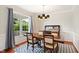 Dining room with hardwood floors, natural light, and a stylish chandelier, perfect for hosting gatherings at 704 Valleywater St, Fuquay Varina, NC 27526