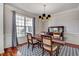 Inviting dining room with a stylish chandelier, large window, and classic wallpaper at 704 Valleywater St, Fuquay Varina, NC 27526