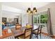 Chic dining area adjacent to the living room, with hardwood floors and a designer light fixture at 704 Valleywater St, Fuquay Varina, NC 27526