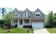 Charming two-story home featuring a welcoming front porch, beautiful landscaping, and a two-car garage at 704 Valleywater St, Fuquay Varina, NC 27526