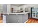 Stylish kitchen with white cabinets, stainless steel appliances, and a breakfast bar with decorative paneling at 704 Valleywater St, Fuquay Varina, NC 27526
