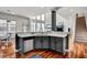 Spacious kitchen with stainless steel appliances, gray cabinetry and marbled countertops with dining area and staircase at 704 Valleywater St, Fuquay Varina, NC 27526