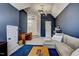 Spacious living room with a comfy sofa, desk and dark blue accent wall at 704 Valleywater St, Fuquay Varina, NC 27526