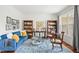 Cozy living room with a blue couch, bright blue rug, and a large window, creating a relaxing atmosphere at 704 Valleywater St, Fuquay Varina, NC 27526