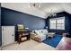 Cozy living room featuring a comfortable sofa, a blue rug and contemporary light fixtures at 704 Valleywater St, Fuquay Varina, NC 27526