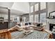 Open-concept living room with seamless flow to the kitchen, a fireplace, and lots of natural light at 704 Valleywater St, Fuquay Varina, NC 27526