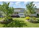Well-maintained backyard with lush lawn, manicured landscaping, and screened-in porch at 79 Tarwick Ave, Chapel Hill, NC 27516