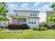 Spacious backyard with green grass, colorful landscaping, patio area, and screened porch at 79 Tarwick Ave, Chapel Hill, NC 27516