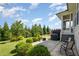 Large backyard with a concrete patio, lush landscaping, mature trees, and a grill at 79 Tarwick Ave, Chapel Hill, NC 27516