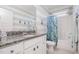 Bathroom with dual vanity, granite countertops, decorative anchors, and shower with nautical shower curtain at 79 Tarwick Ave, Chapel Hill, NC 27516
