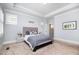 Comfortable bedroom features a tray ceiling, a comfortable bed, and neutral carpeting at 79 Tarwick Ave, Chapel Hill, NC 27516