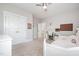Bright bedroom featuring carpet, a ceiling fan, and an open workspace with natural light at 79 Tarwick Ave, Chapel Hill, NC 27516