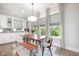 Bright dining area features a wooden table, bench seating, and plenty of natural light at 79 Tarwick Ave, Chapel Hill, NC 27516