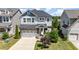 Charming two-story home with stone accents, an attached garage, and a well-manicured lawn at 79 Tarwick Ave, Chapel Hill, NC 27516