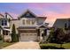 Charming two-story home featuring stone accents and a well-manicured lawn beneath a colorful sky at 79 Tarwick Ave, Chapel Hill, NC 27516