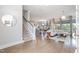 Inviting foyer view with hardwood flooring, a staircase, and an open view into the living area at 79 Tarwick Ave, Chapel Hill, NC 27516