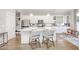 Modern kitchen with white cabinetry, marble countertops, stainless steel appliances, and bar seating at 79 Tarwick Ave, Chapel Hill, NC 27516