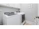 Bright laundry room with modern, white, side-by-side washer and dryer at 79 Tarwick Ave, Chapel Hill, NC 27516