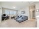 Upstairs living room features a plush blue sofa, neutral carpeting, and lots of natural light at 79 Tarwick Ave, Chapel Hill, NC 27516