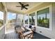 Relaxing screened porch with wooden furniture, ceiling fan, and open view at 79 Tarwick Ave, Chapel Hill, NC 27516